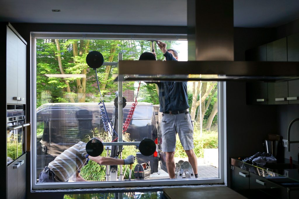 BrightView Glass installers removing old, inefficient windows from a home during home improvement project.